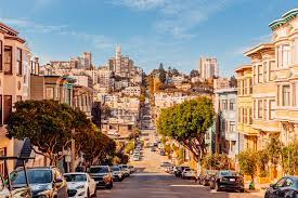 Steep hill in San Francisco with cars on it.