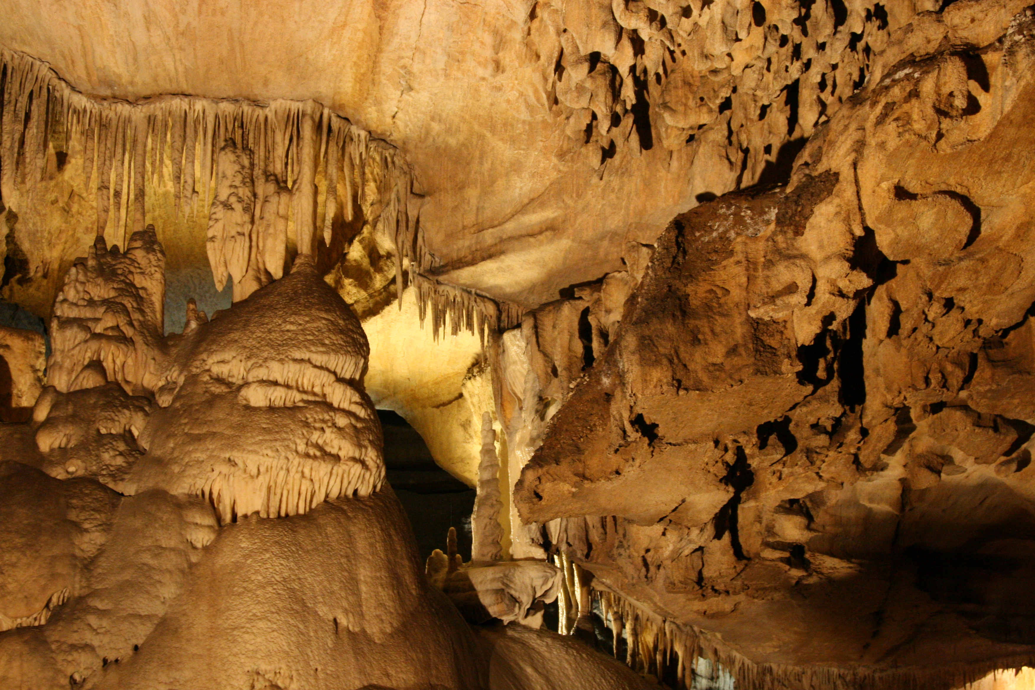 A cave with intricate stalactite and stalagmite formations.