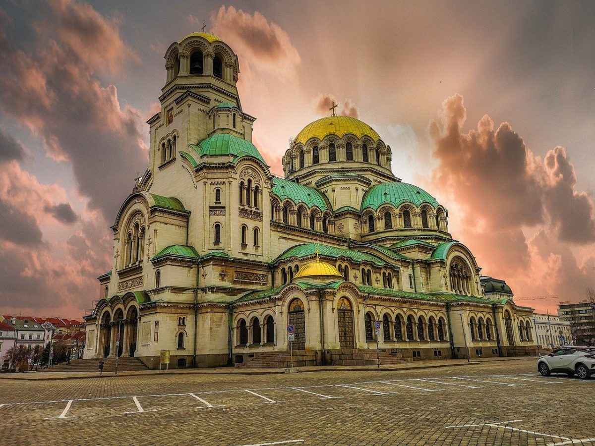 A picture of a cathedral with a sunset in the background.